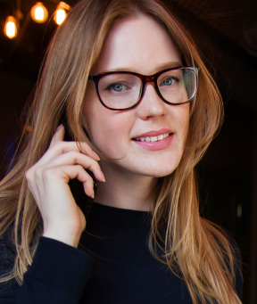 Smiling blond woman with glasses